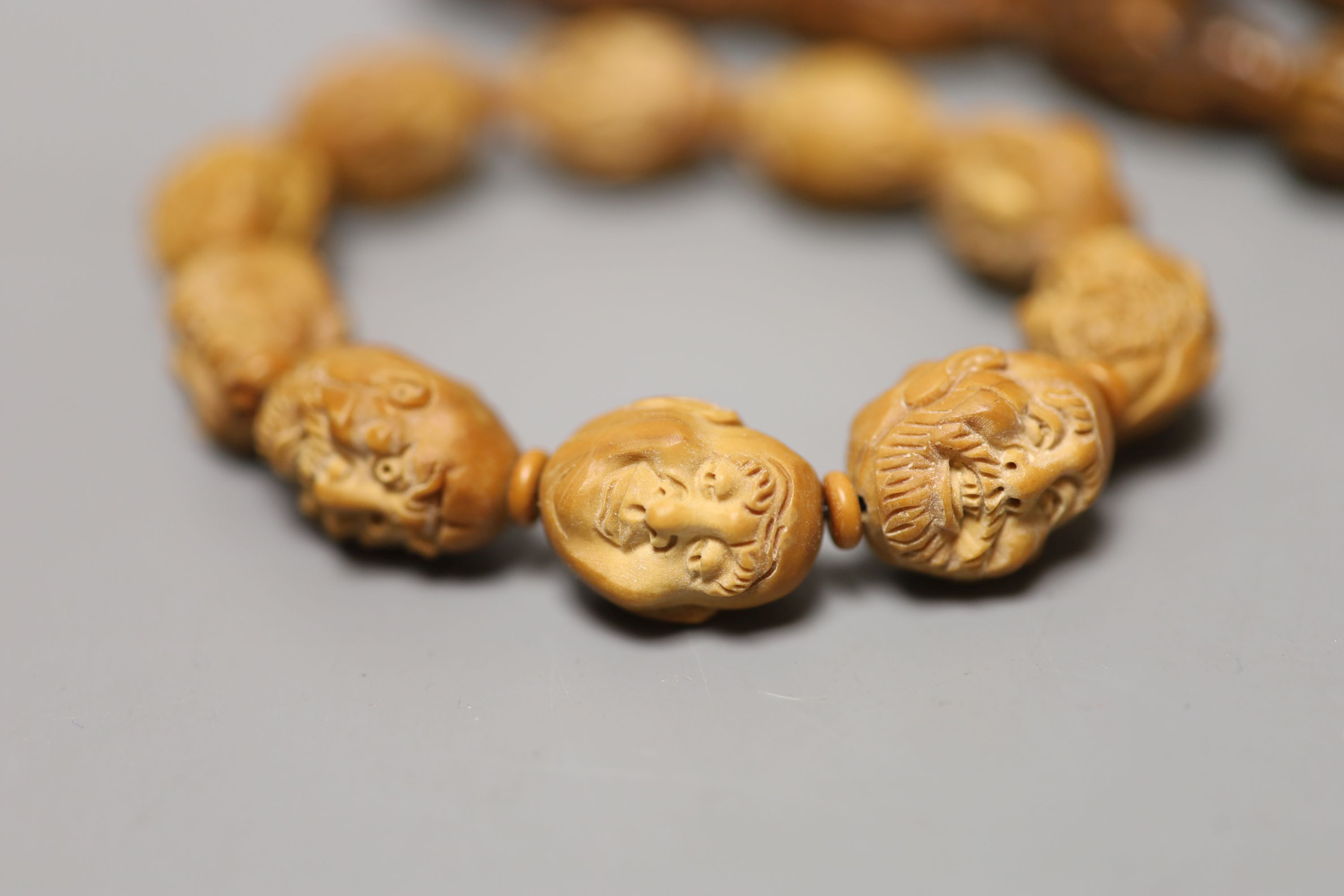 A coquilla nut necklace, bracelet and two small ornamental carvings